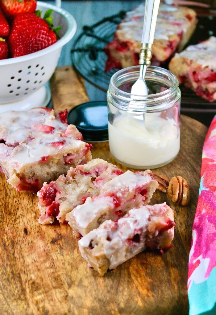 Strawberry bread with a glaze on a cutting board