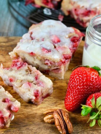 Glazed strawberry bread on a cutting board