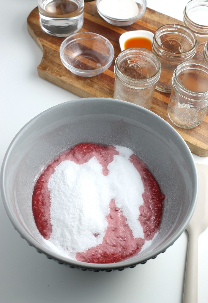 We have to add the sugar for our strawberry freezer jam and mix it up well before it goes into jars.