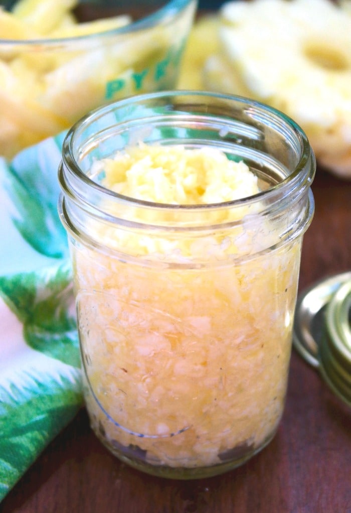 Crushed pineapple in a clear mason jar. 