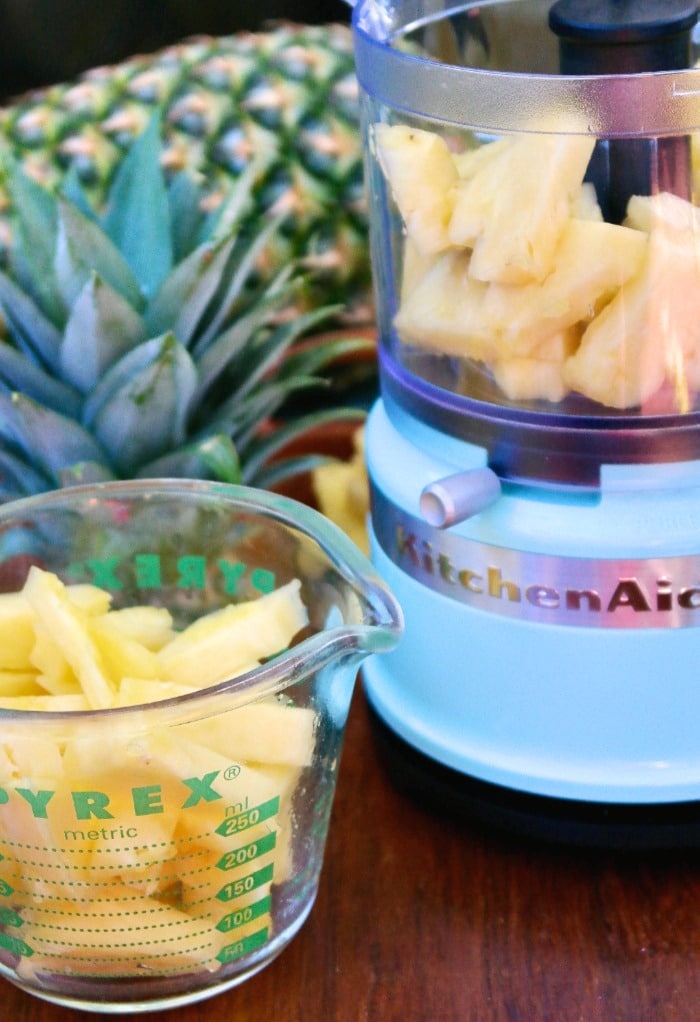 chunks of fresh pineapple in a measuring cup