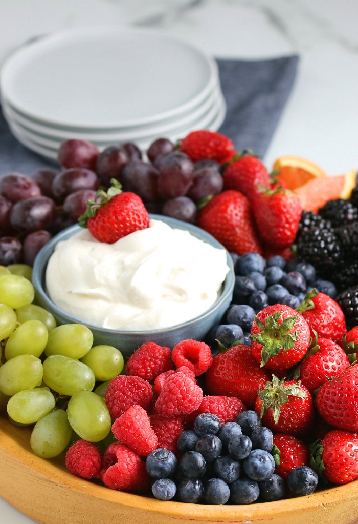 Here we see a fresh strawberry being dipped into the fruit dip before it's eaten. 