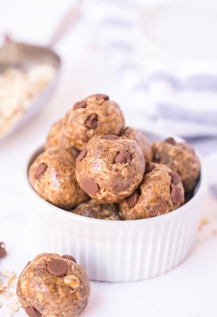 White bowl full of no bake healthy peanut butter balls