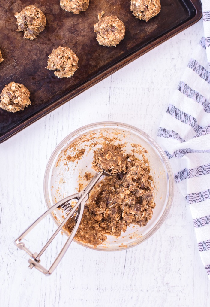 All ingredients for energy balls mixed in a clear bowl