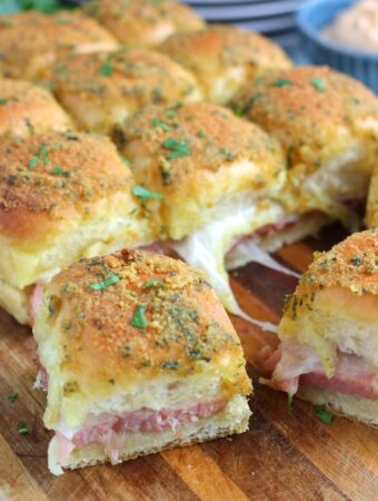 A side view of the finished recipe for ham sliders shows off the delicious layers of this incredibly simple recipe.