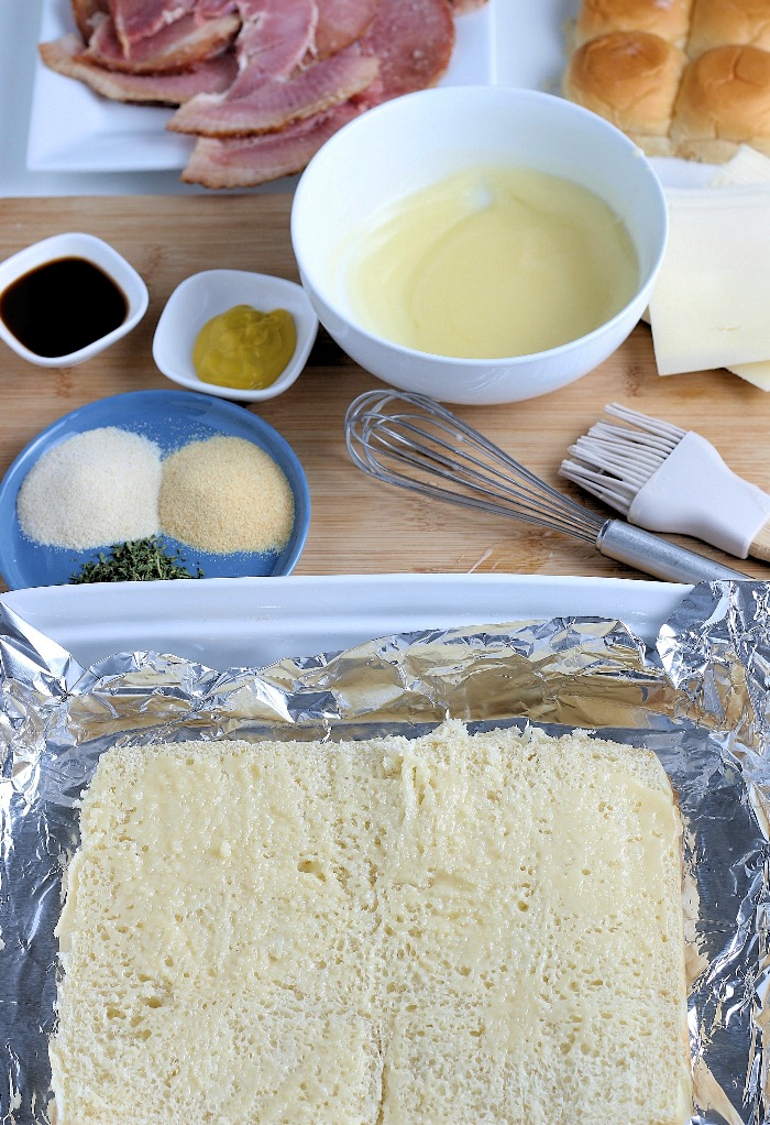 First we have to prepare the bread by cutting them in half and laying the full bottom layer on some foil.