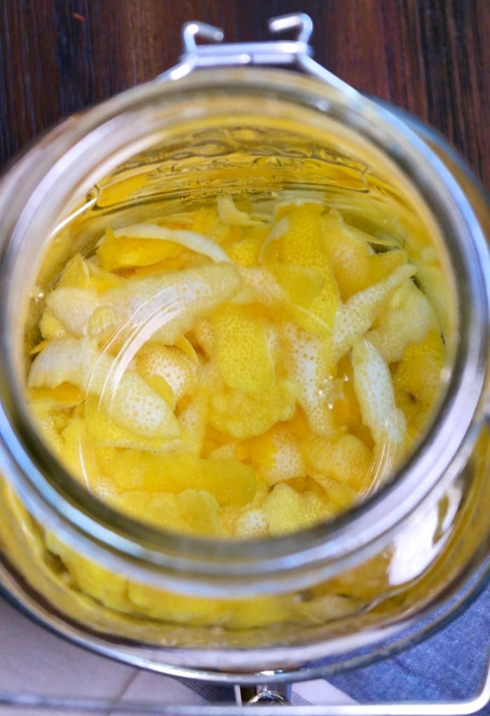 All ingredients in mason jar making limoncello.