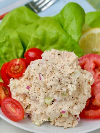 Low carb tuna salad with tomatoes on a white plate.