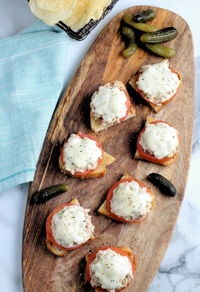 An overhead photo of tuna melt sandwiches topped with cheese. 