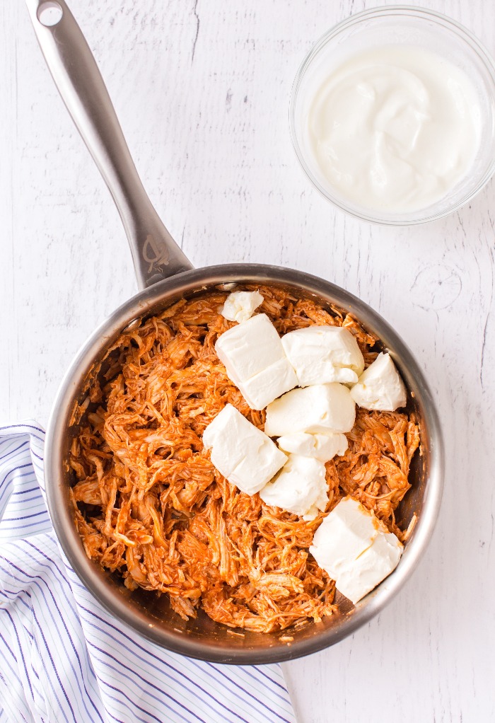 Here is a sauce pan with shredded chicken and cream cheese.