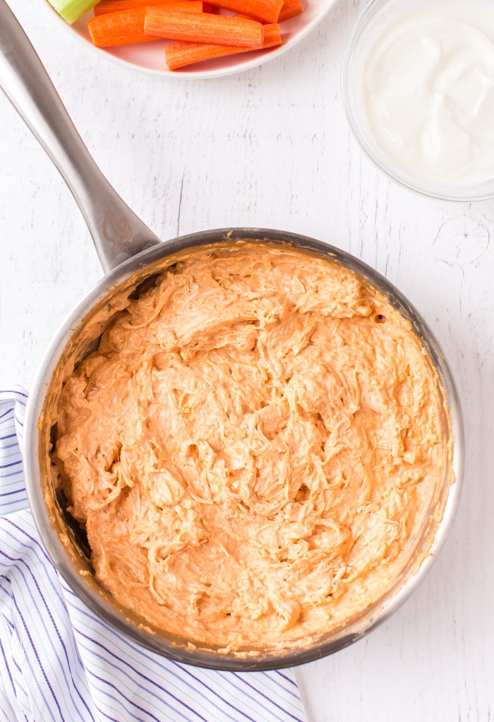 Melted cream cheese with chicken for keto buffalo chicken dip