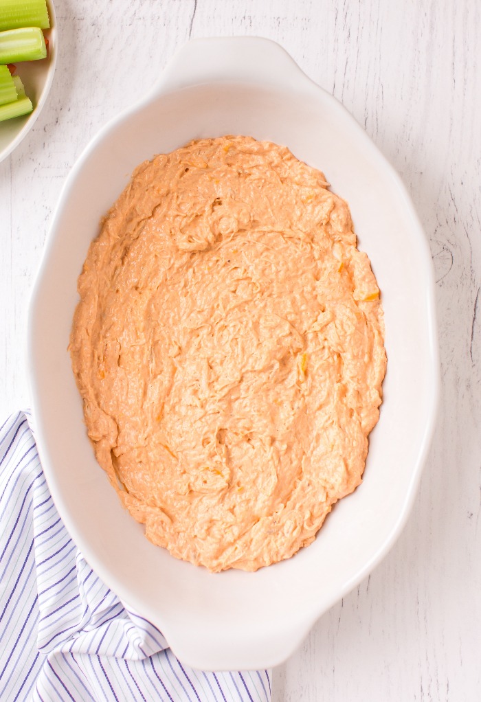 Place the keto buffalo chicken dip in a oven proof pan to be baked.