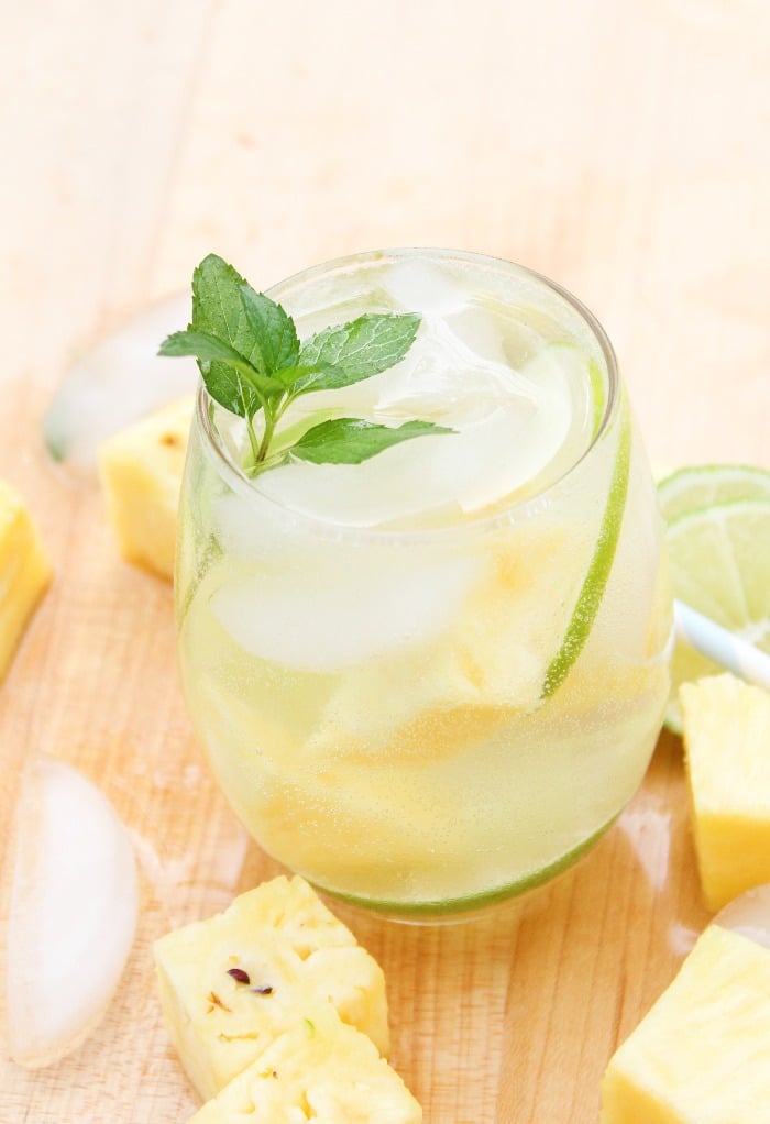 Pineapple mojito in a clear glass with a sprig of mint