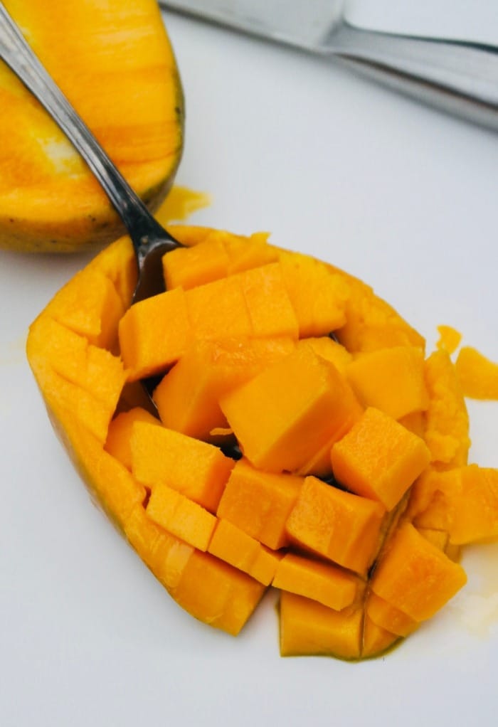 Half of a mango cut into chunks.