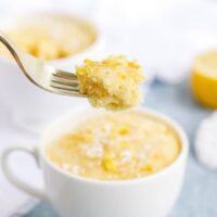 A forkful of keto lemon mug cake right out of the white mug.