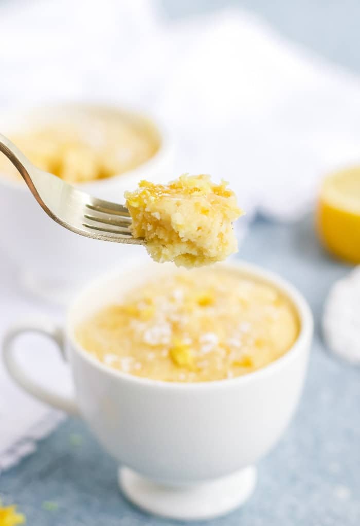 A forkful of keto lemon mug cake right out of the white mug.