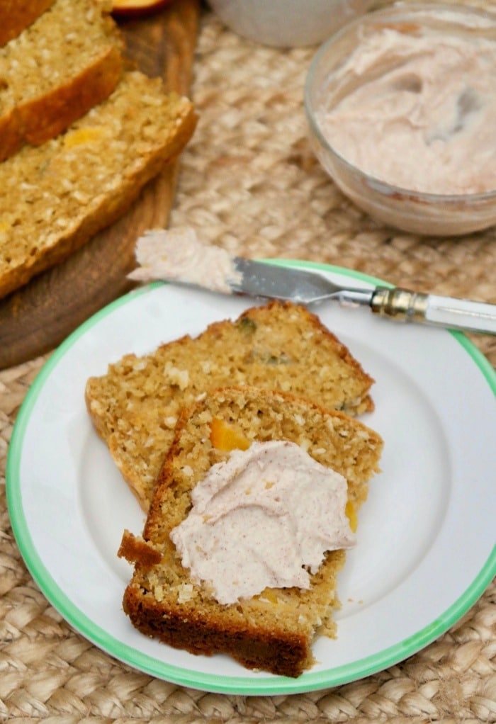 Fresh baked peach bread topped with whipped cream cheese cinnamon spread