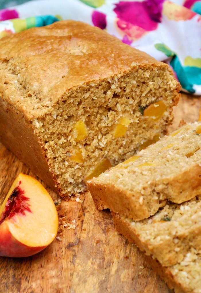 Homemade peach bread sliced on a cutting board