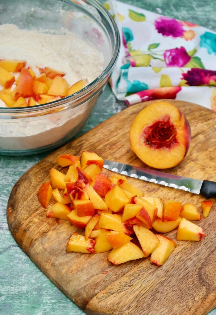 Fresh diced peaches on a cutting board. 