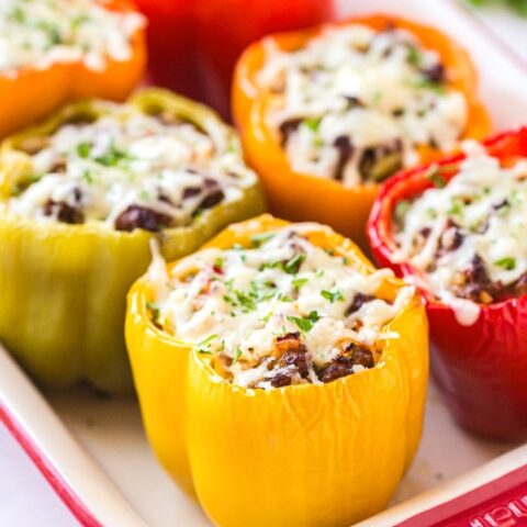 Casserole dish filled with stuffed peppers.