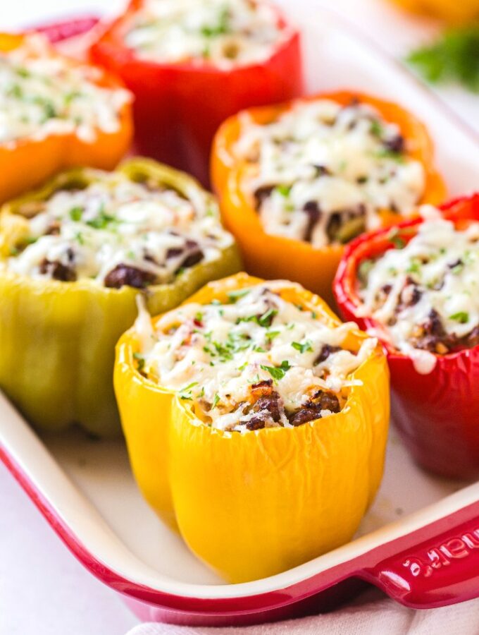 Casserole dish filled with stuffed peppers.