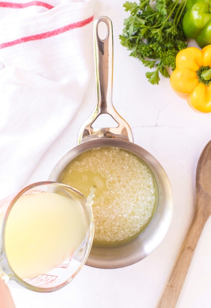 Adding chicken broth to rice