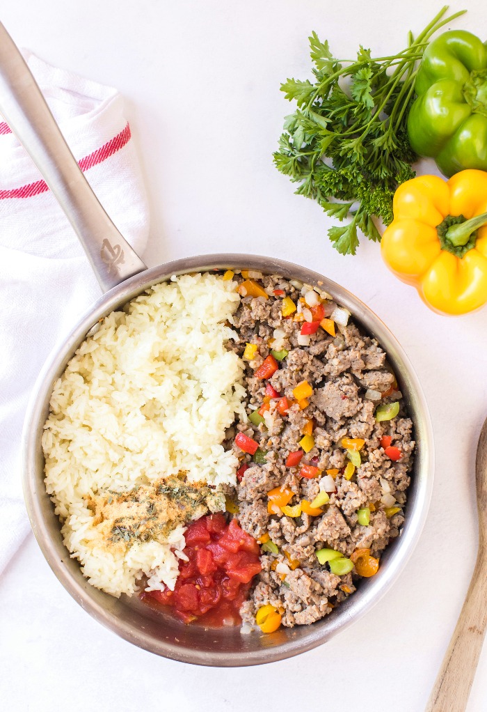 Adding all ingredient for Italian stuffed peppers in a large skillet