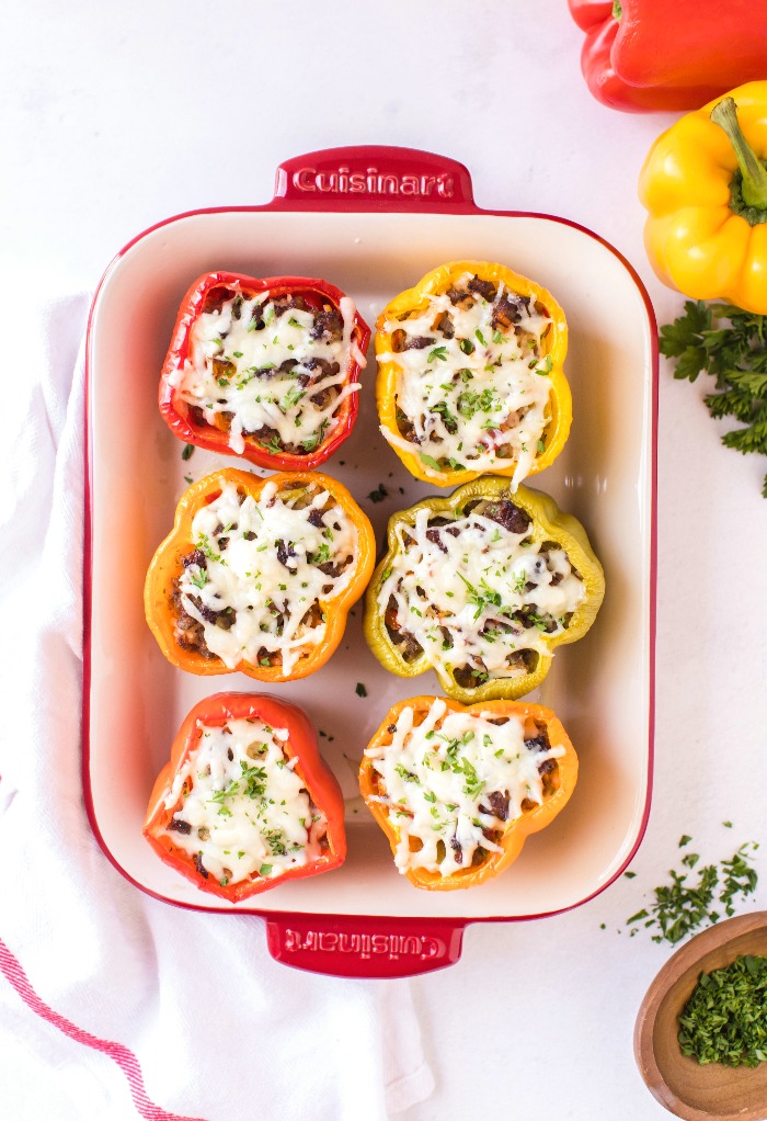 Add cheese to filled bell peppers before cooking