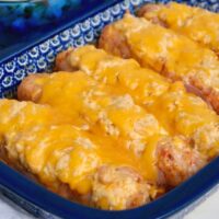 Blue casserole dish with cheese stuffed sausage.