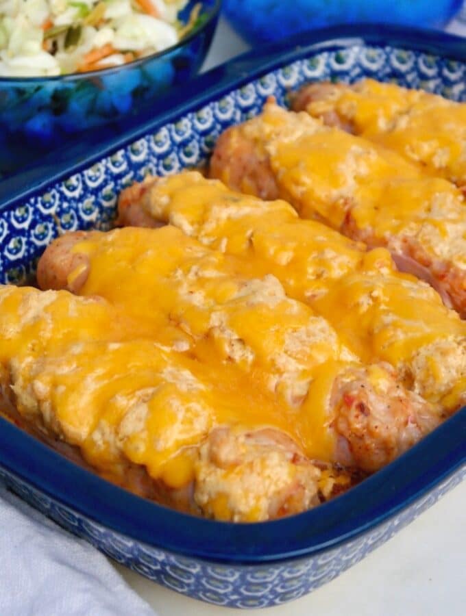 Blue casserole dish with cheese stuffed sausage.