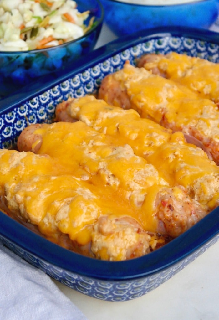 Blue casserole dish with cheese stuffed sausage.