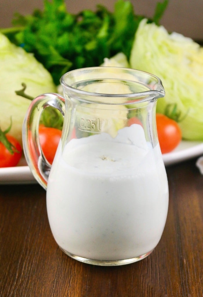 Homemade blue cheese dressing in a clear small pitcher