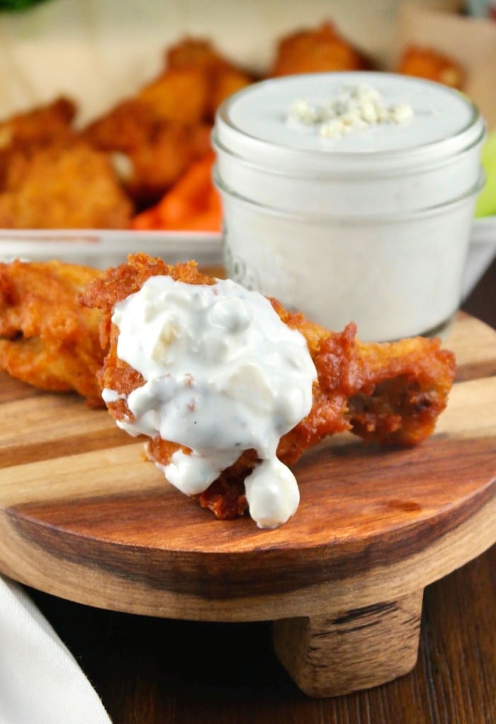 A chicken drumstick with blue cheese sauce. 