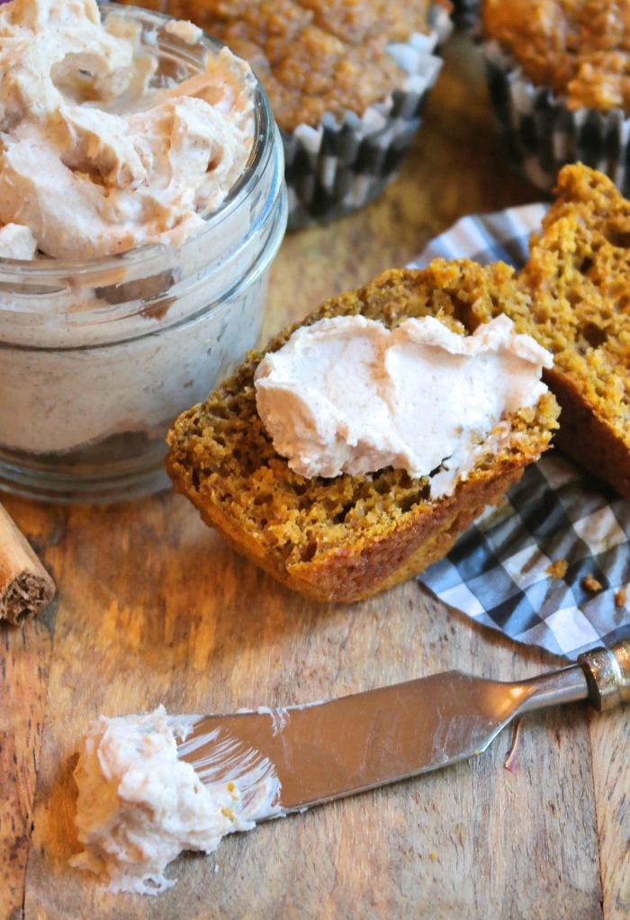 Half of a pumpkin muffin topped with cinnamon cream cheese. 