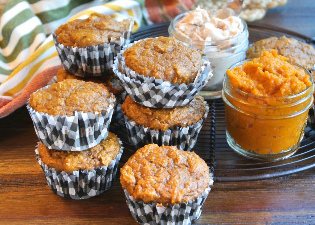 Horizontal view of a half dozen baked pumpkin muffins on a cooling rack. 