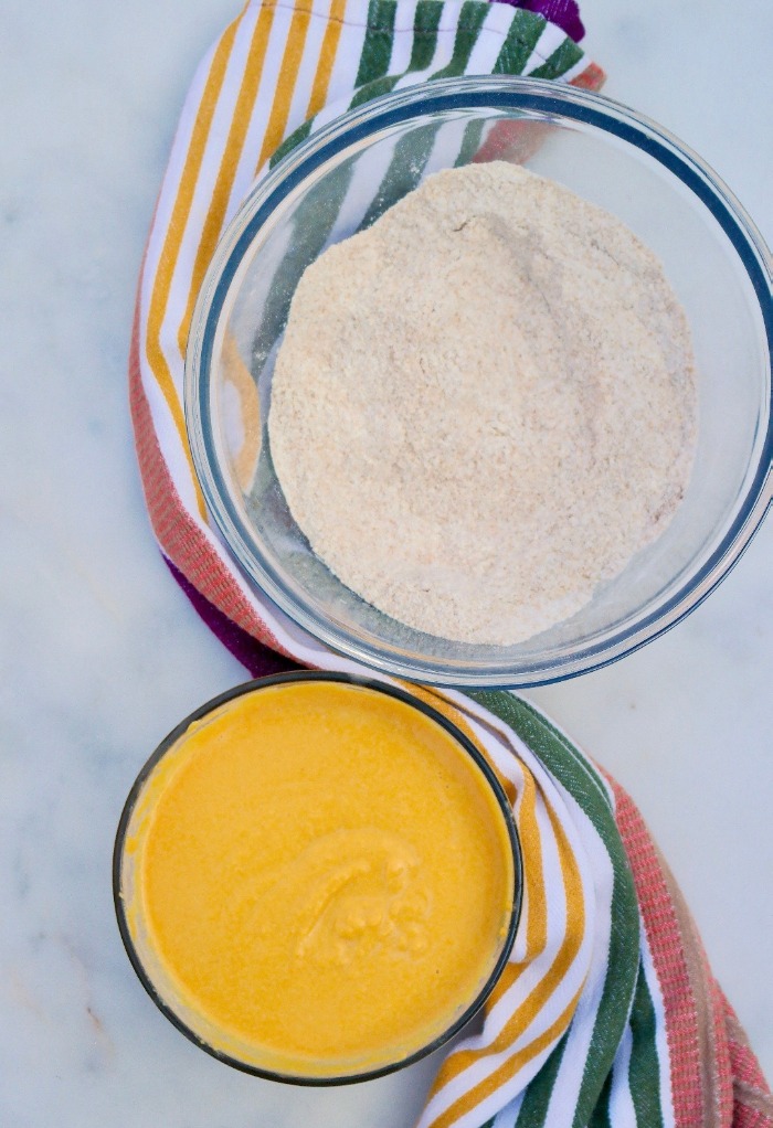 Two mixing bowls of wet and dry ingredients for Sweet Potato Muffin Recipe.