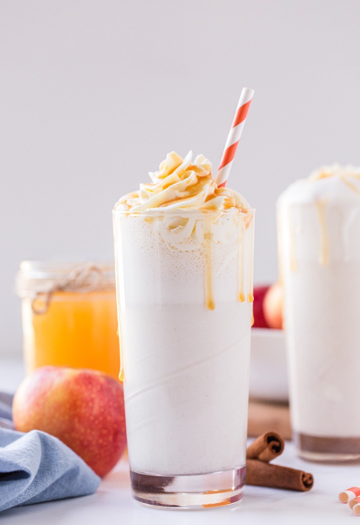 Apple cider milkshake topped with whipped cream and caramel topping. 