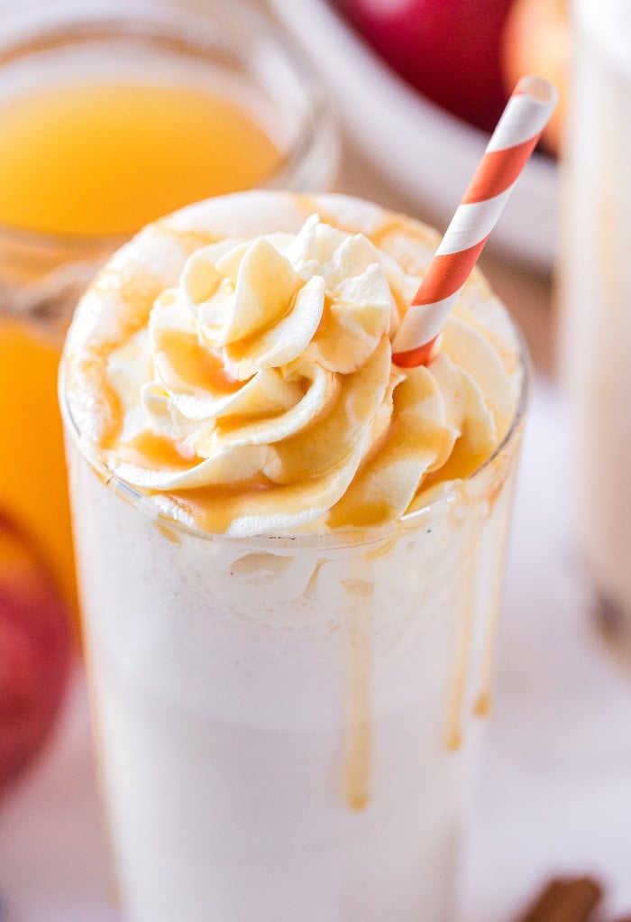 A homemade apple milkshake topped with whipped cream ready to be enjoyed.