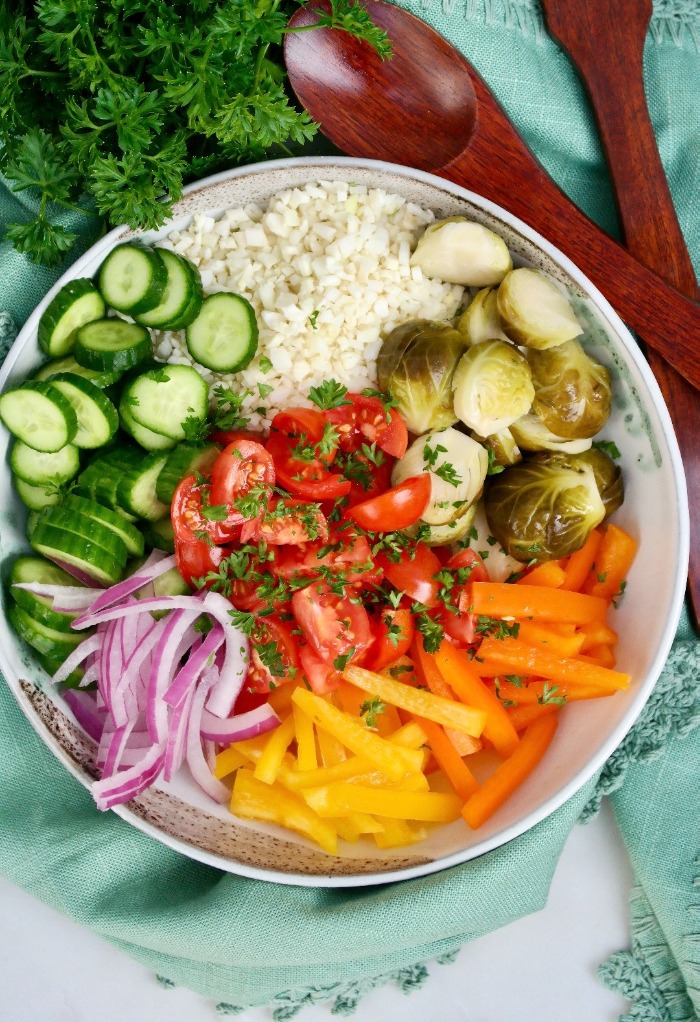 Diced vegetables in a white salad bowl.