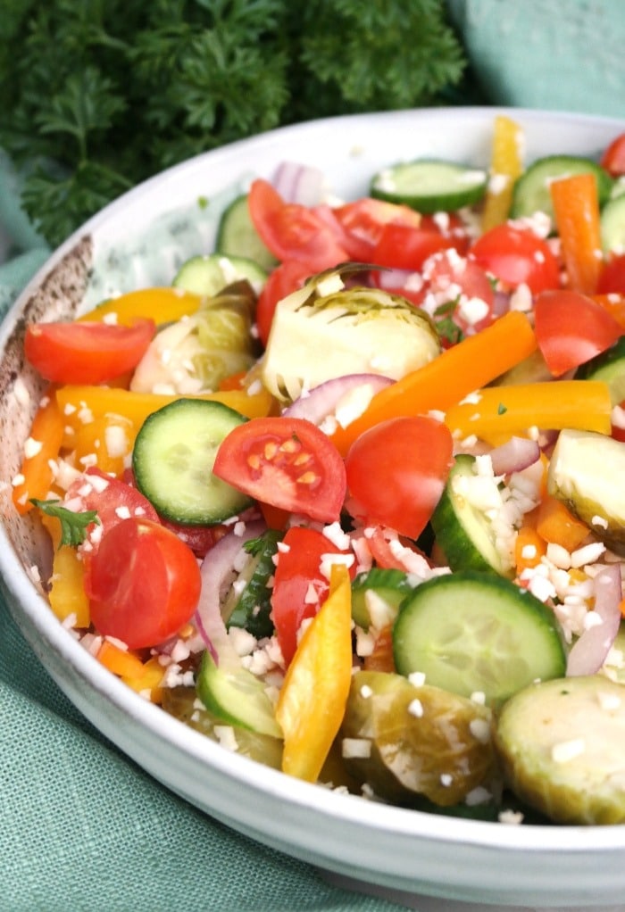 A large salad bowl filled with cauliflower rice and vegetables. 