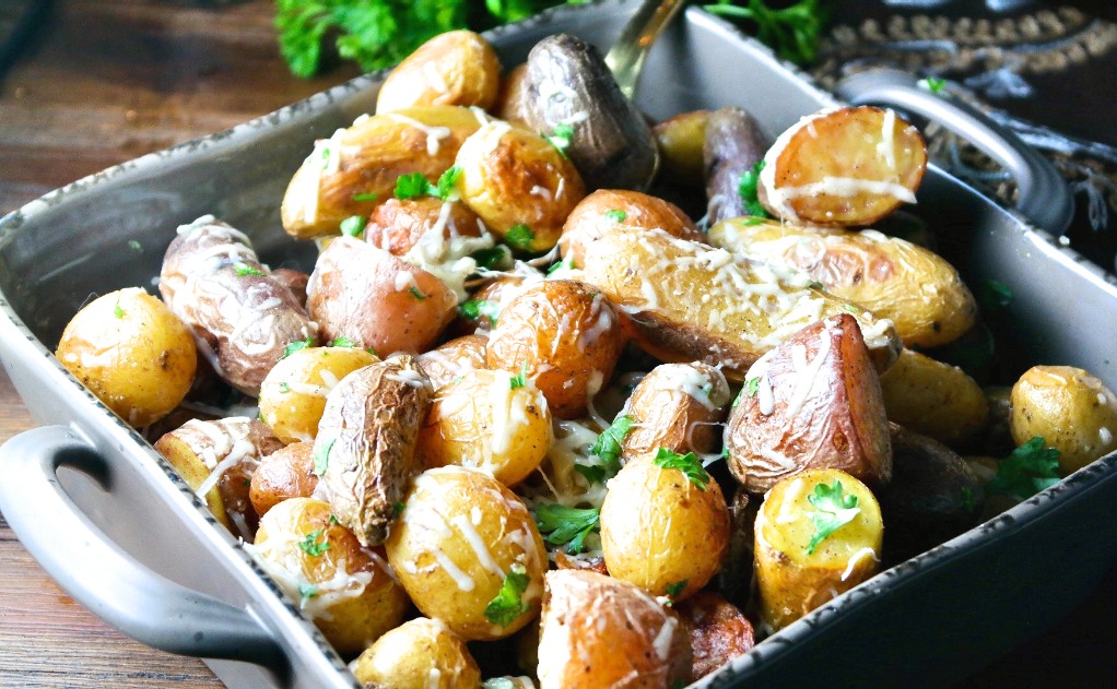 A horizontal view of cooked baby potatoes in a serving dish. 