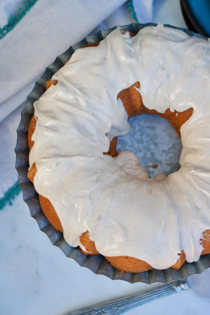 Top view of a whole spice cake topped with brown butter icing.