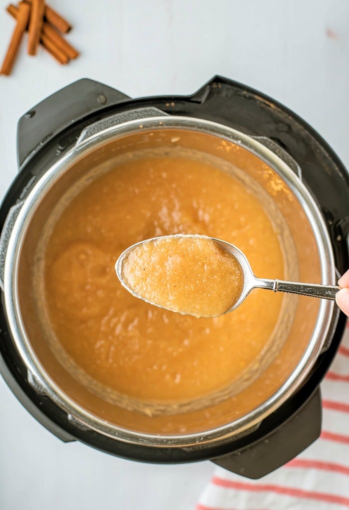 A spoonful of cooked applesauce. 