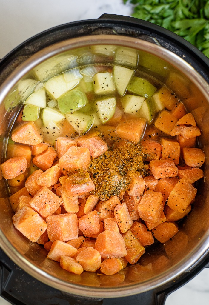 Top view of all ingredients in an instant pot for butternut squash soup.