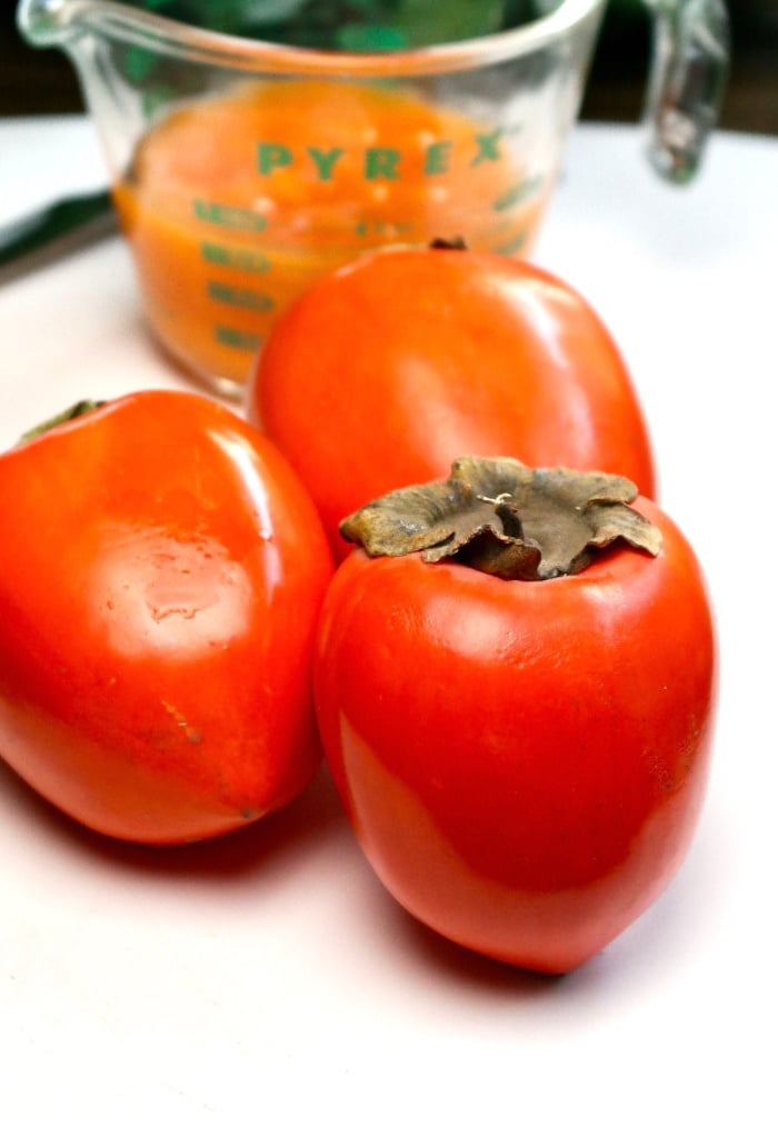 Photo of hachiya persimmon on a white cutting board.