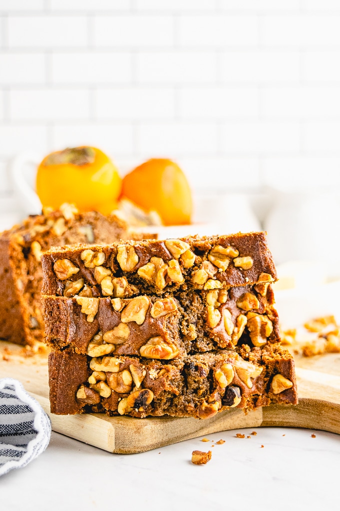 Sliced quick bread topped with walnuts. 