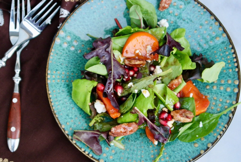 Green salad with persimmons, pecans and goat cheese. 