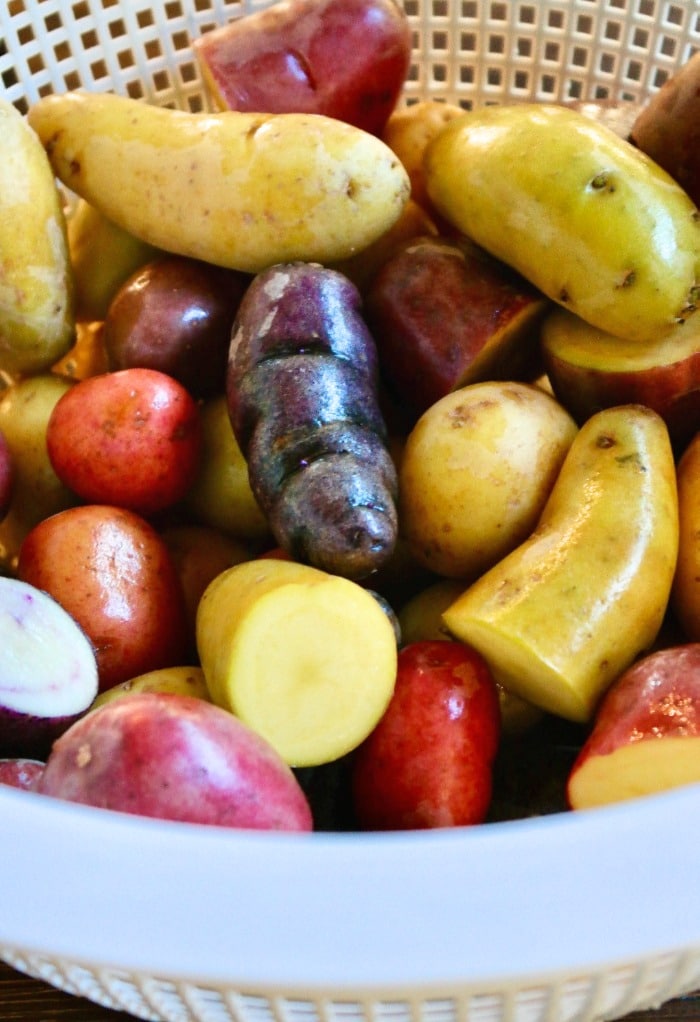 Clean fingerling potatoes in a colander.