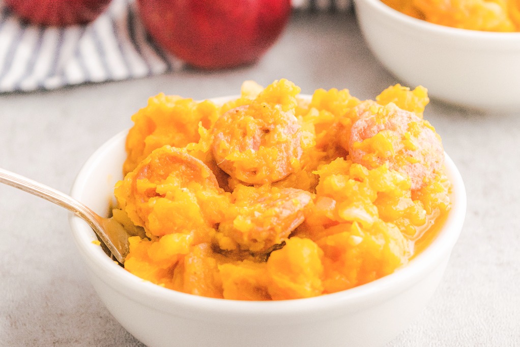 Close up view of sweet potato breakfast bowl with chicken sausage and apple. 