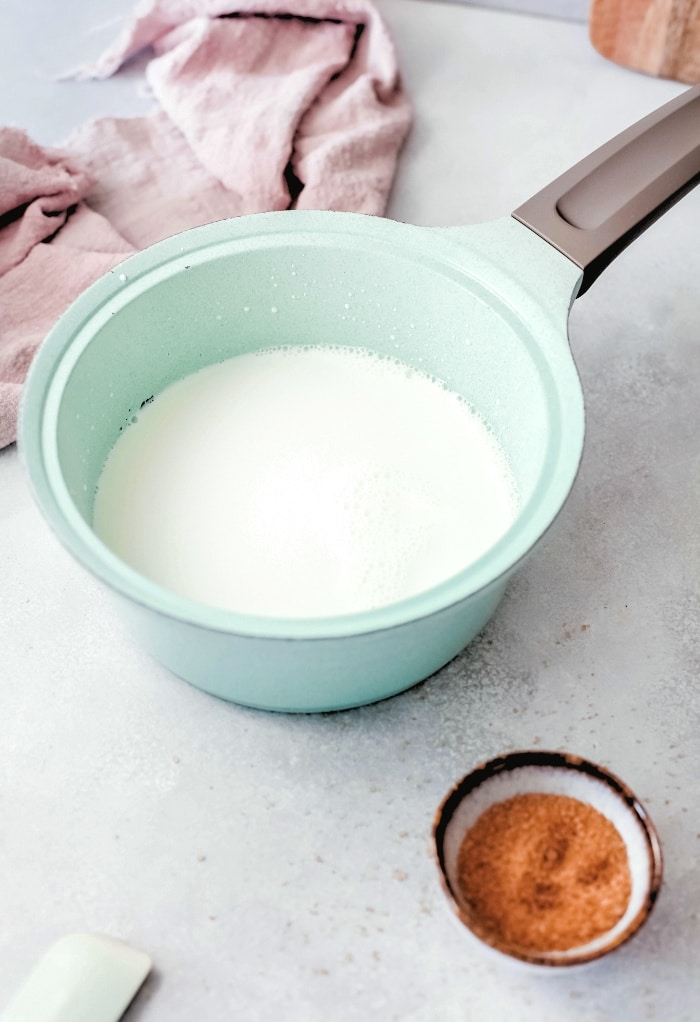 A saucepan with warm milk ready to make latte.